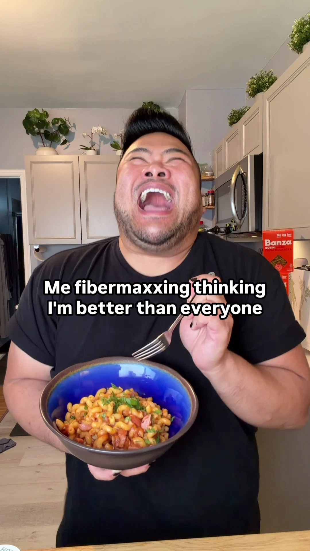 I laugh while holding a bowl of pasta as text reads, Me fibermaxxing thinking I’m better than everyone.
