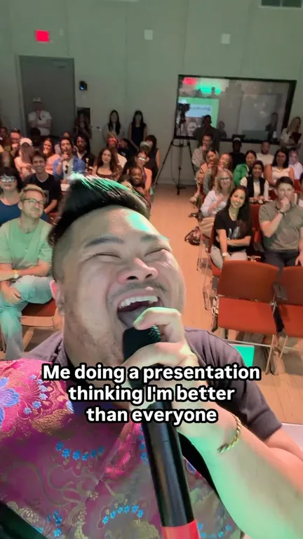 I smile with a microphone in front of the Camp Edits audience.