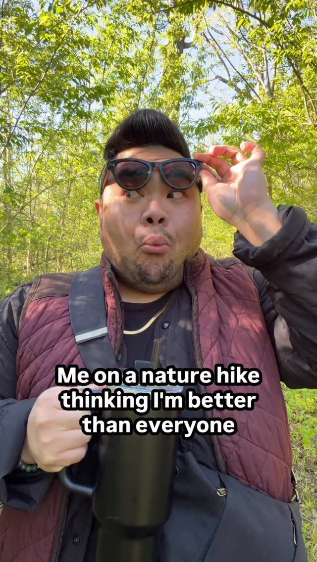 I lift my Ray-Ban Meta glasses while making a playful face on a leafy trail beneath text about feeling better than everyone on a nature hike.