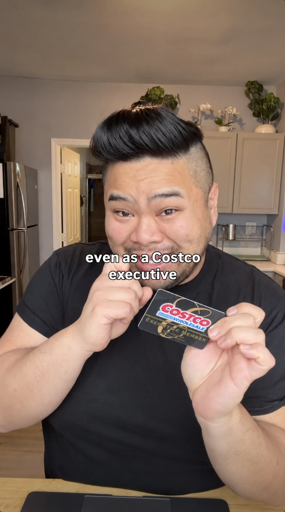 RV Mendoza holds a Costco Executive membership card in a frame from The Costco Rental Car Hack.
